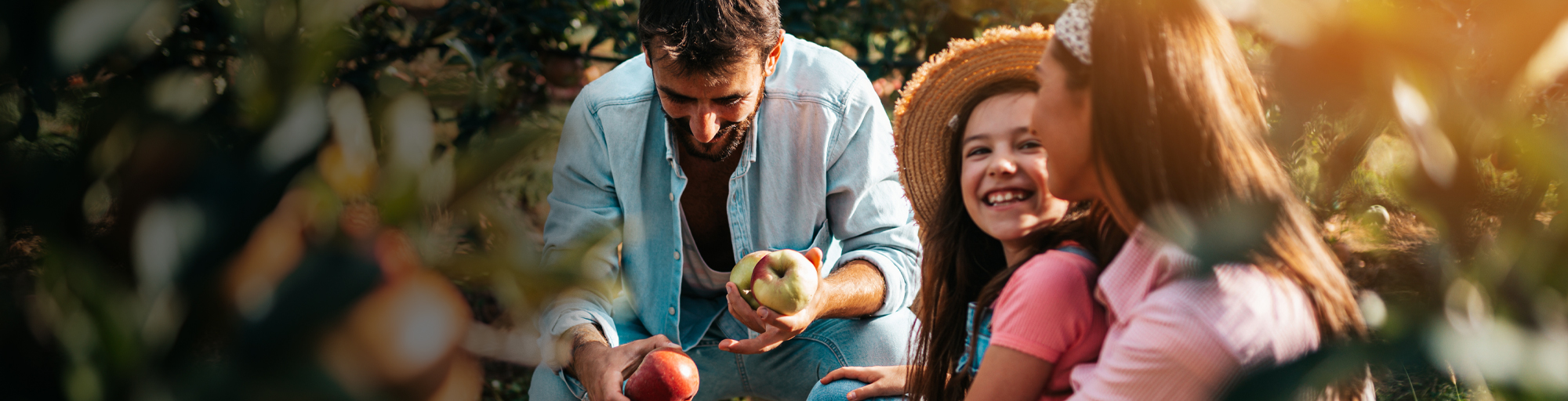 Family of three in an apple orchard