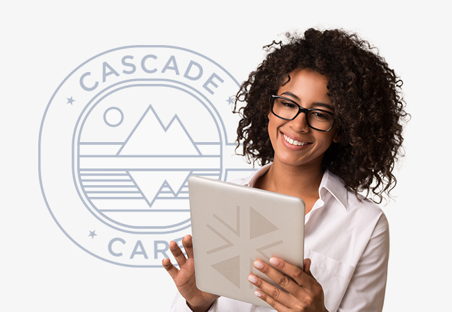 A lady looking at a tablet smiling with a cascade care logo behind