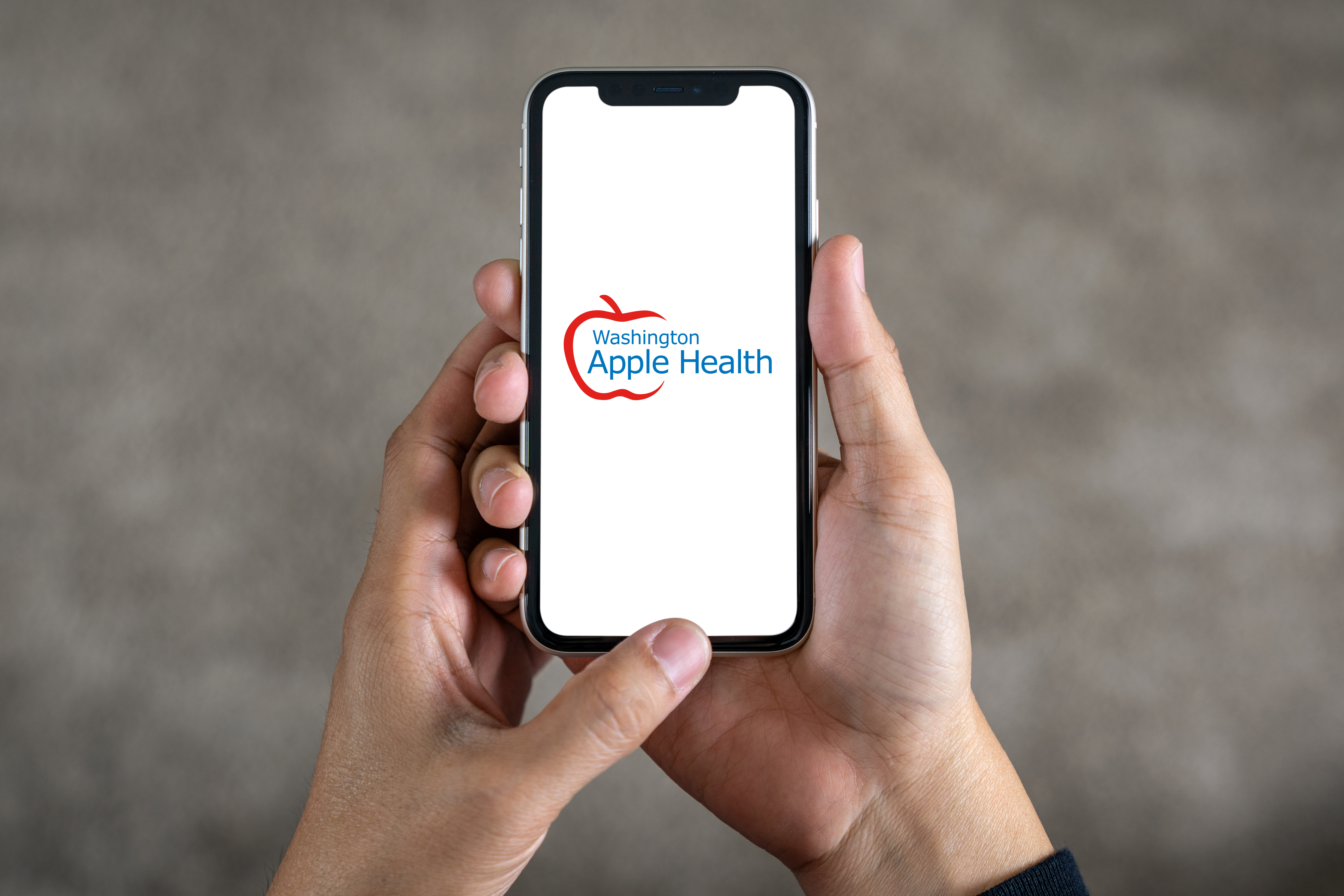 Washington Apple Health logo on a cellphone.
